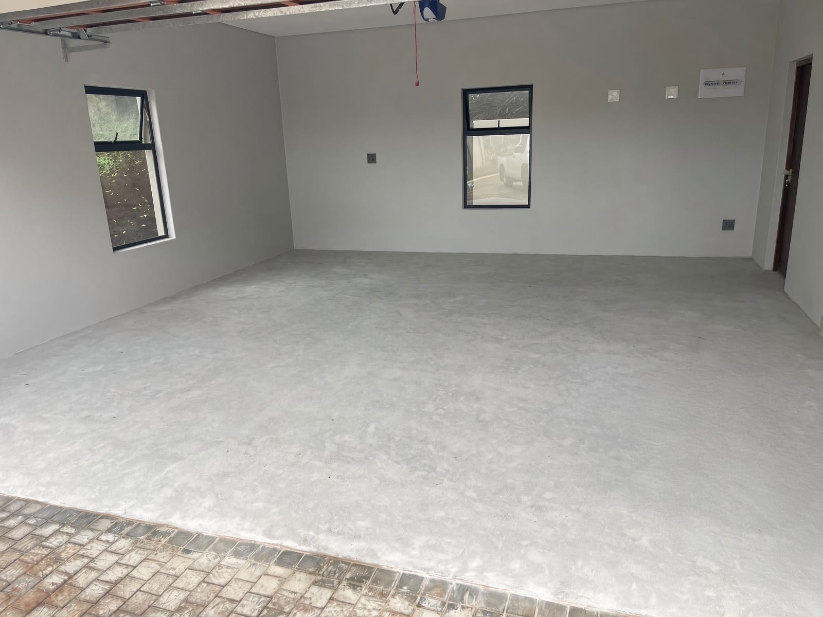 Garage floor before epoxy - bare screed