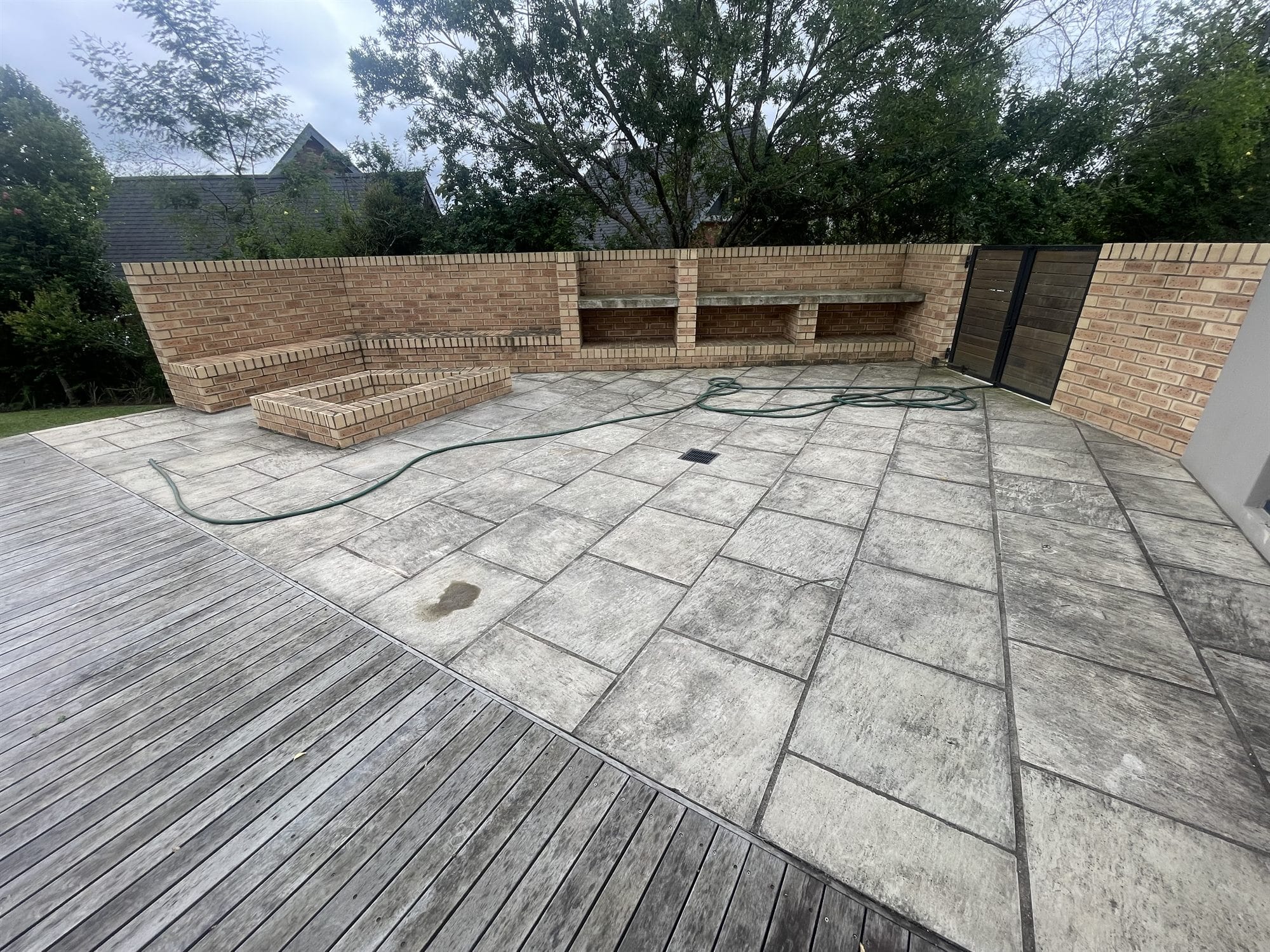 Sandstone patio before cleaning - surface darkened with years of grime