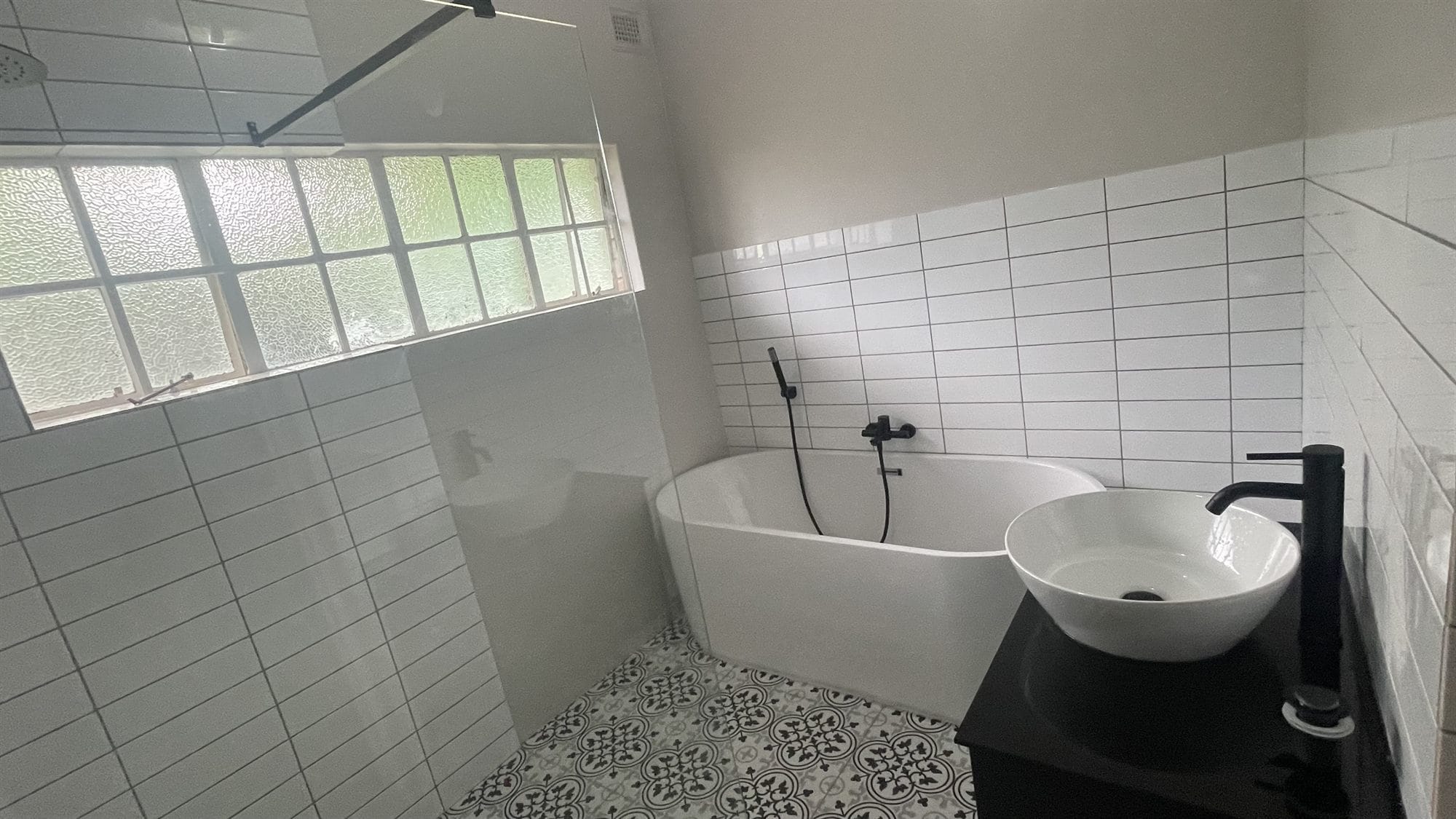 Modern bathroom renovation with freestanding bath