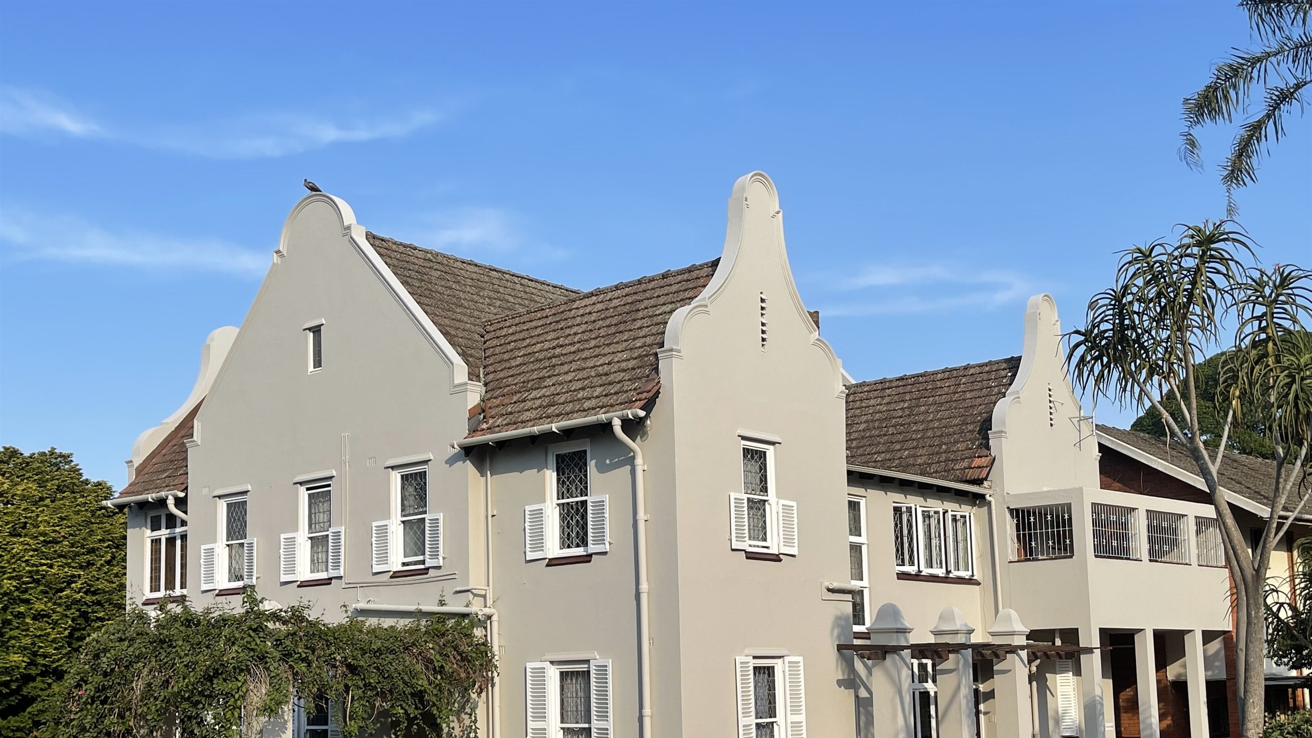 Heritage Cape Dutch building with shaped gables, repainted in off-white by Star Painters & Renovators